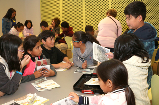 Students reviewing photos at the Museum of Tolerance.